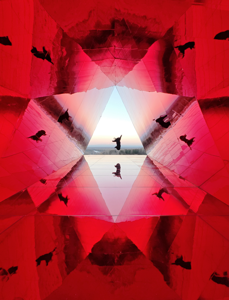 reflective red chamber emerges from prism mountain shelter’s charred wood shell