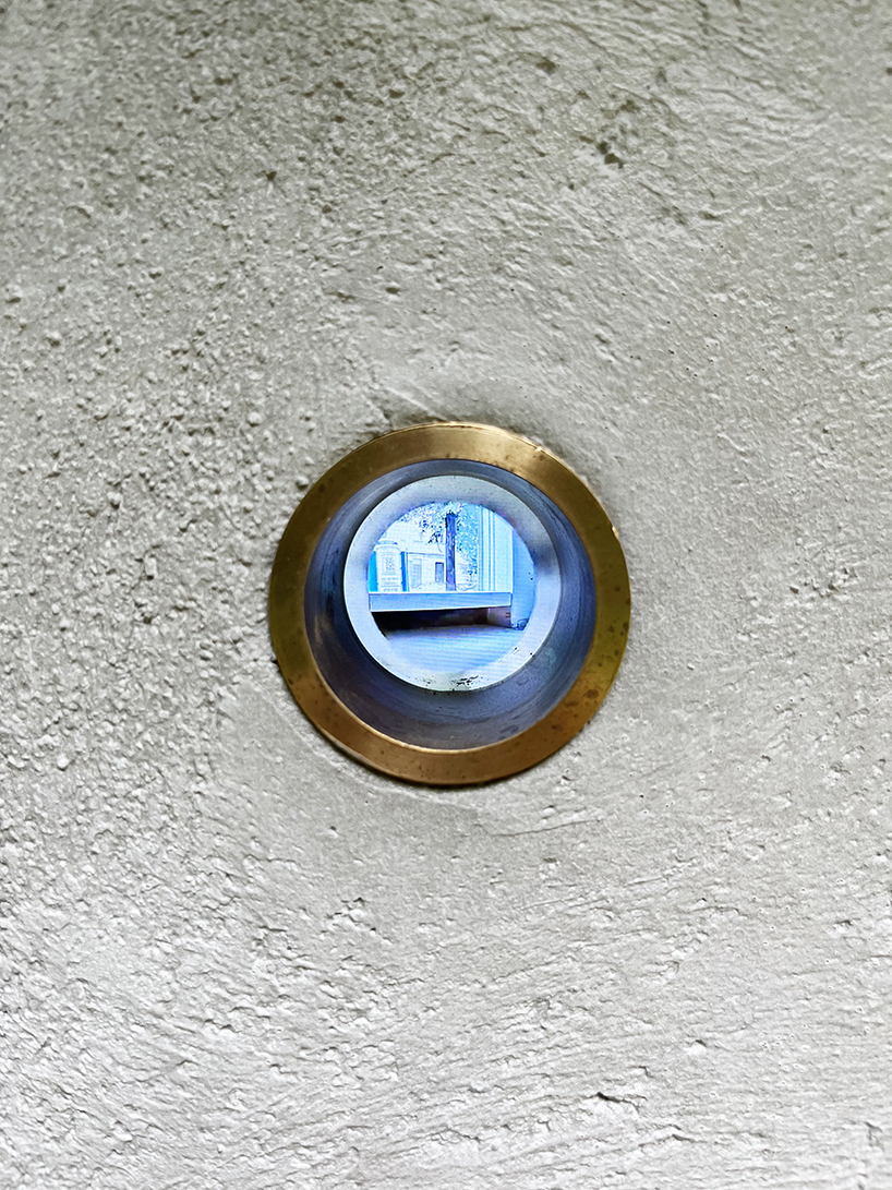 twin concrete cube sculptures link rokko and berlin through tiny video transmission holes