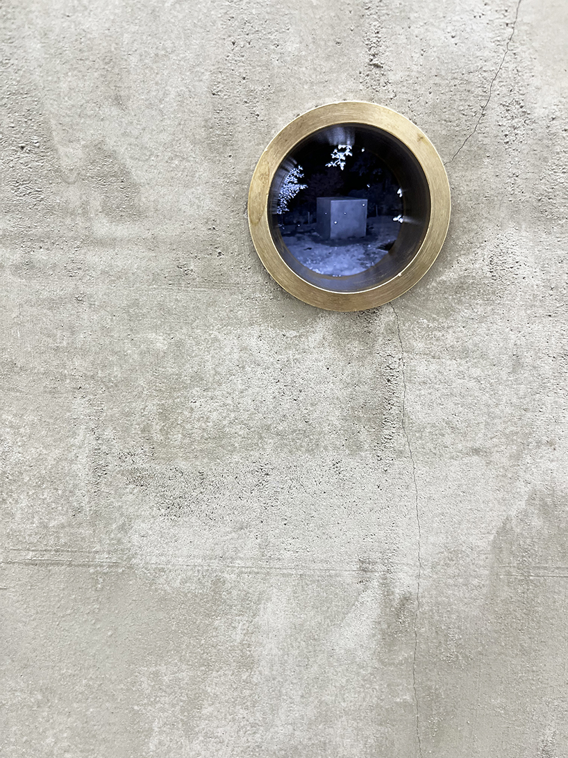 twin concrete cube sculptures link rokko and berlin through tiny video transmission holes
