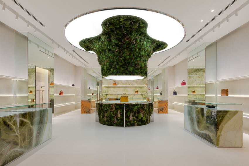 abstract tree installation sprouts from the floor to display premium leather goods