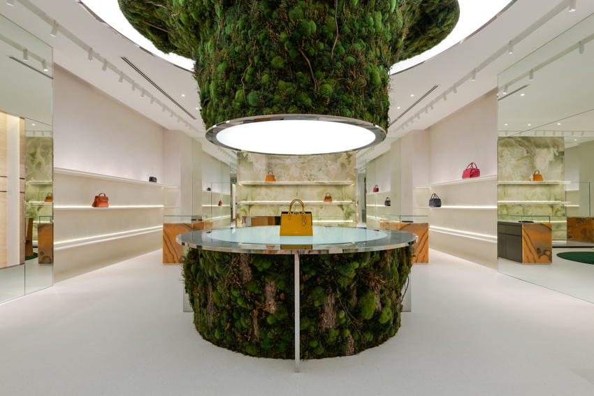 abstract tree installation sprouts from the floor to display premium leather goods