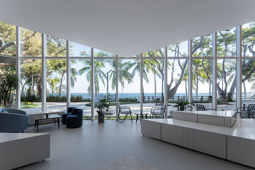 bright red bookshelves shine through glass box bookstore by wutopia lab in china