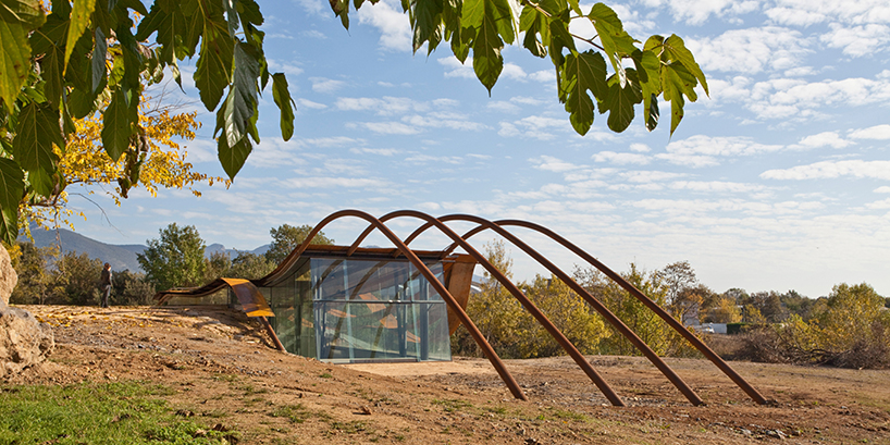 miquel subiras' organic-shaped cultural center in spain mimics its surrounding nature