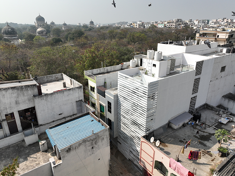 folded steel ribbons envelope narrow row house in india