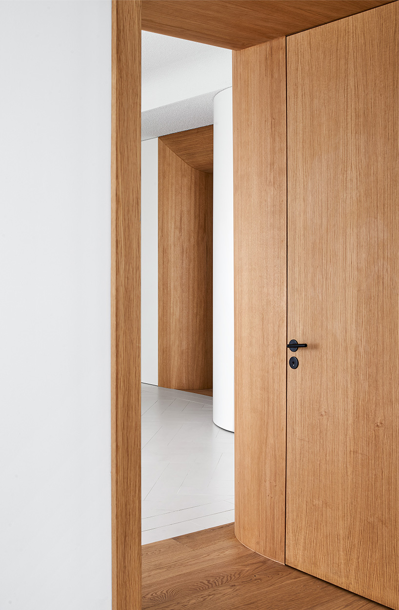 wooden curved casings frame domestic scenes within centuries-old home in madrid