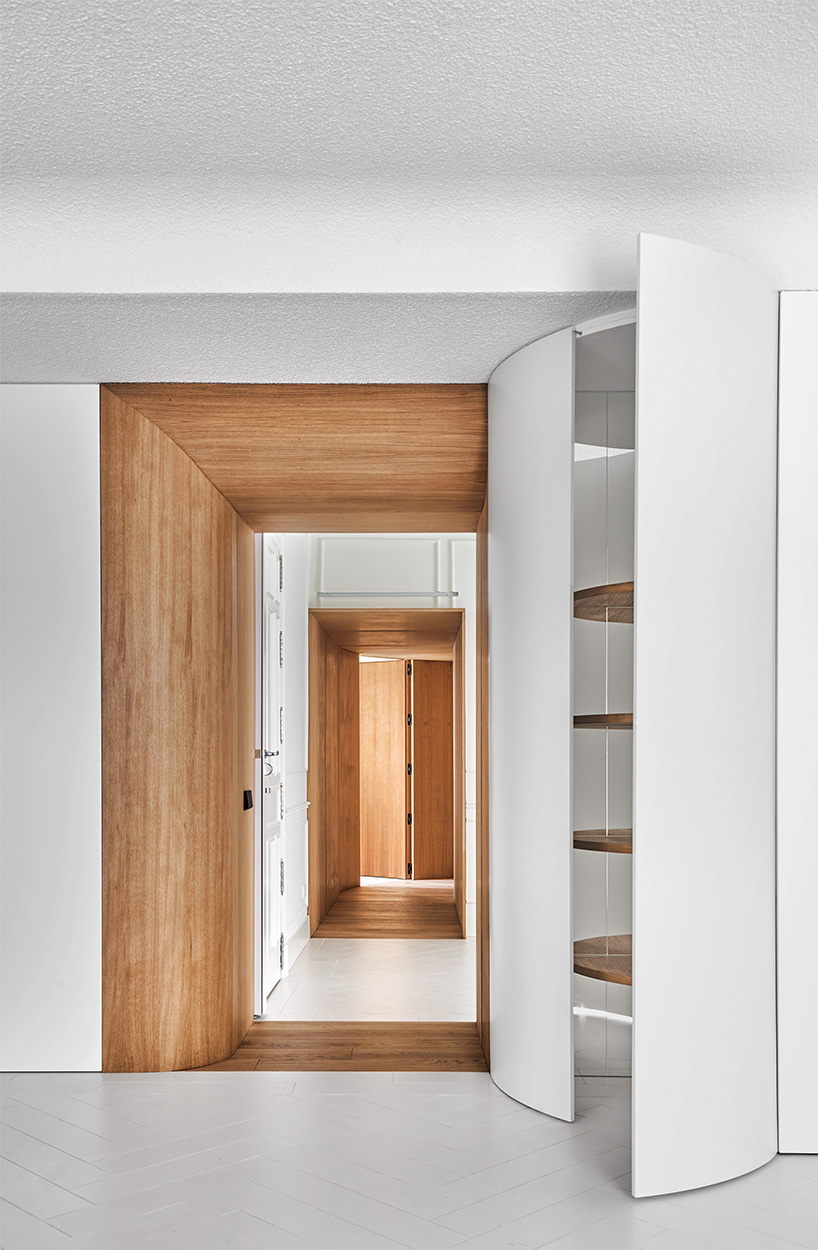 wooden curved casings frame domestic scenes within centuries-old home in madrid