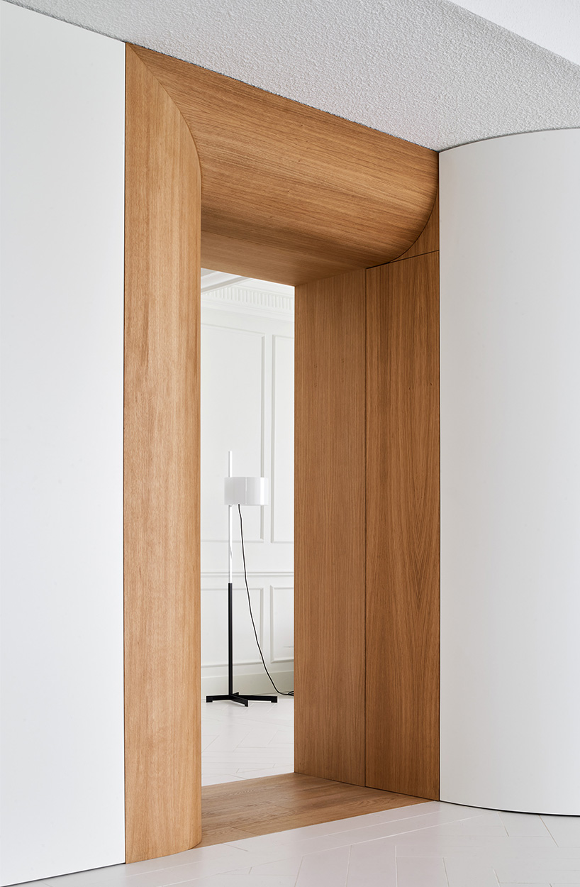 wooden curved casings frame domestic scenes within centuries-old home in madrid