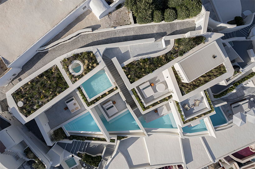 shaped like cubic prisms, kapsimalis architects' hotel rooms echo cave houses in santorini