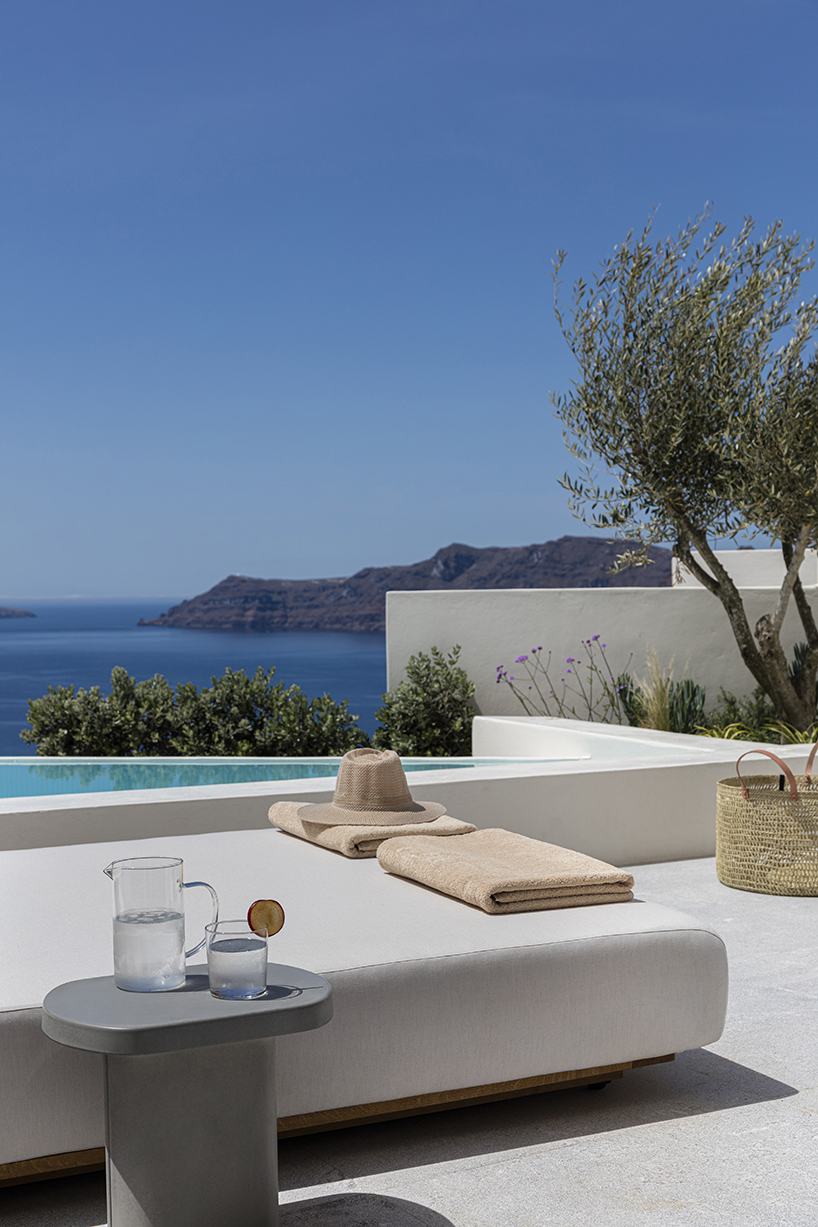 shaped like cubic prisms, kapsimalis architects' hotel rooms echo cave houses in santorini