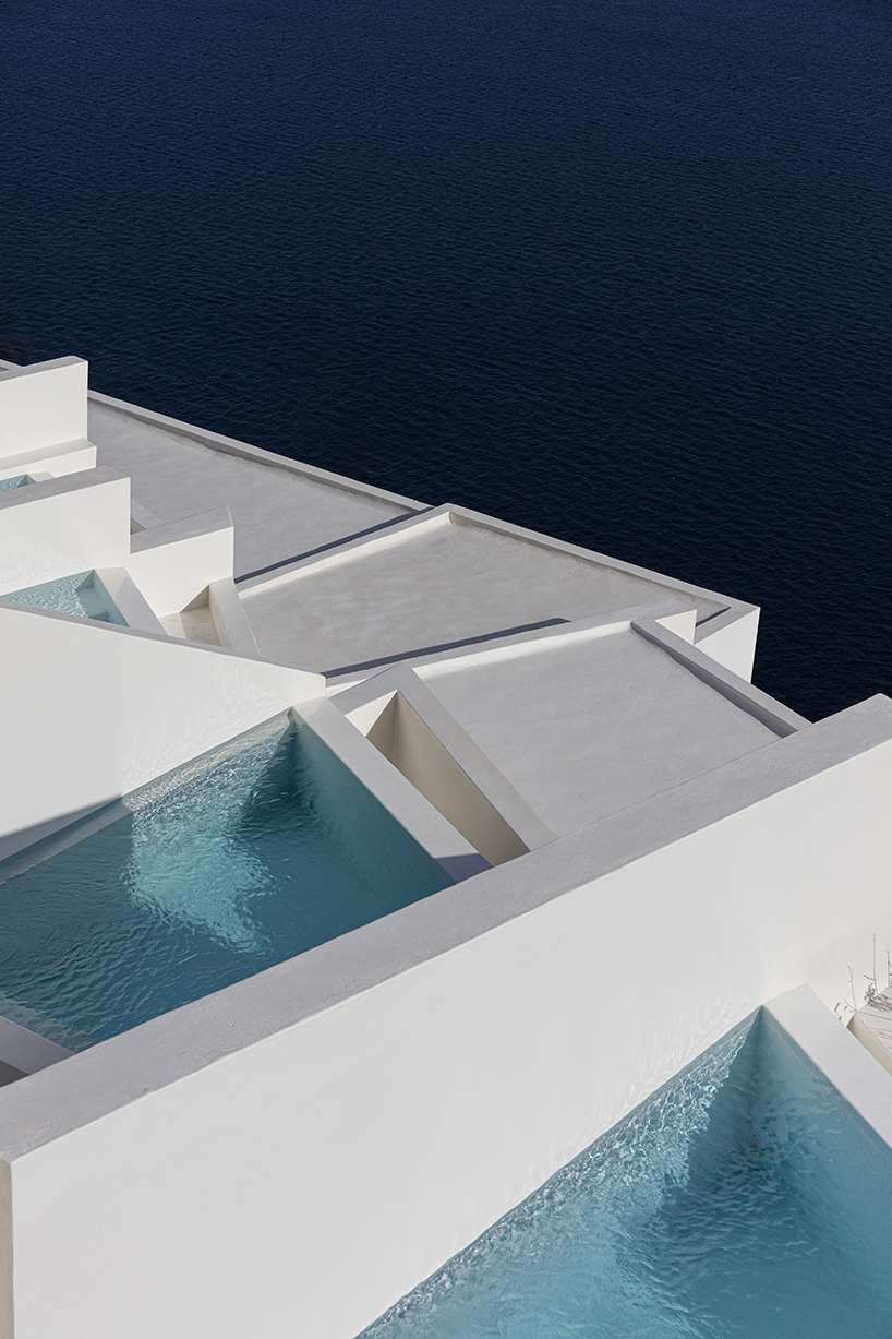 shaped like cubic prisms, kapsimalis architects' hotel rooms echo cave houses in santorini