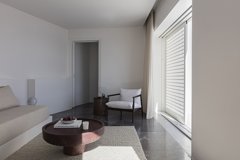 shaped like cubic prisms, kapsimalis architects' hotel rooms echo cave houses in santorini