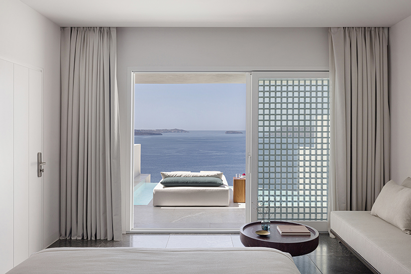 shaped like cubic prisms, kapsimalis architects' hotel rooms echo cave houses in santorini
