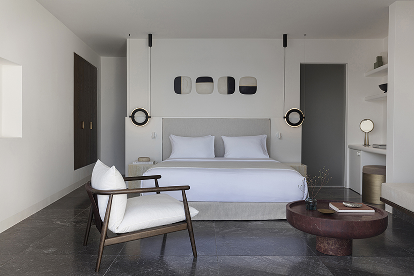 shaped like cubic prisms, kapsimalis architects' hotel rooms echo cave houses in santorini