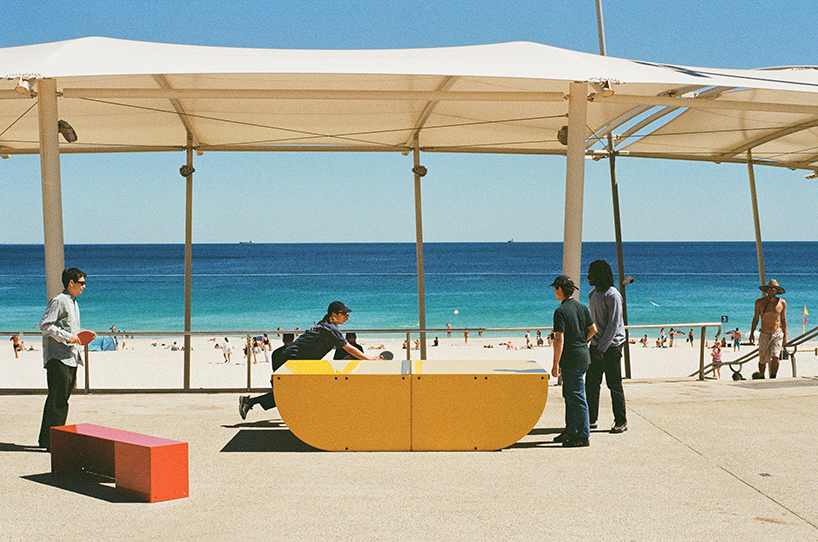 Outdoor table tennis with a yellow mat hero of popp resists all weather conditions