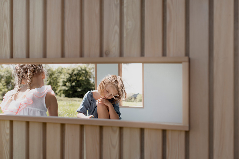 koto prefabricates the 'ilo playhouse' for children using larch timber and recycled rubber designboom