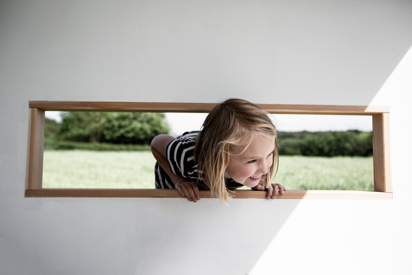 koto prefabricates the 'ilo playhouse' for children using larch timber and recycled rubber designboom