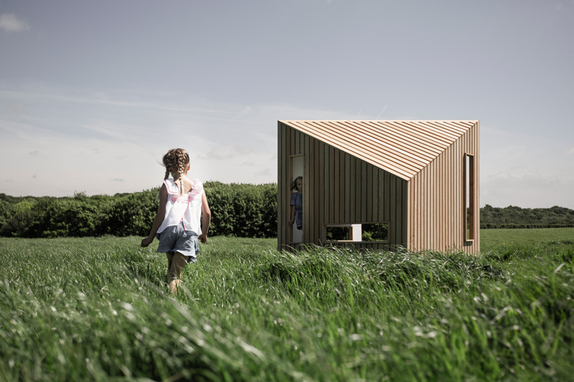 koto prefabricates the 'ilo playhouse' for children using larch timber and recycled rubber designboom