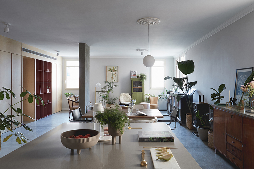 this apartment in tel aviv uses a wooden storage unit to separate private spaces
