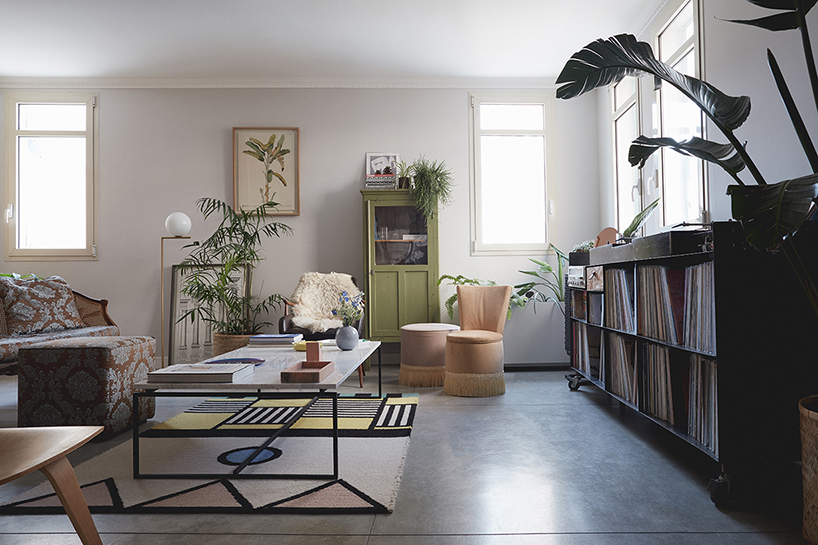 this apartment in tel aviv uses a wooden storage unit to separate private spaces