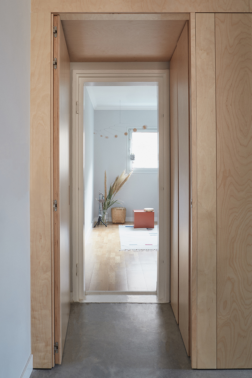 this apartment in tel aviv uses a wooden storage unit to separate private spaces thisisit designboom
