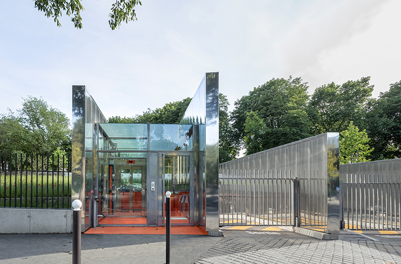 anonyme studio balances the raw structure of an underground parking with red splashes