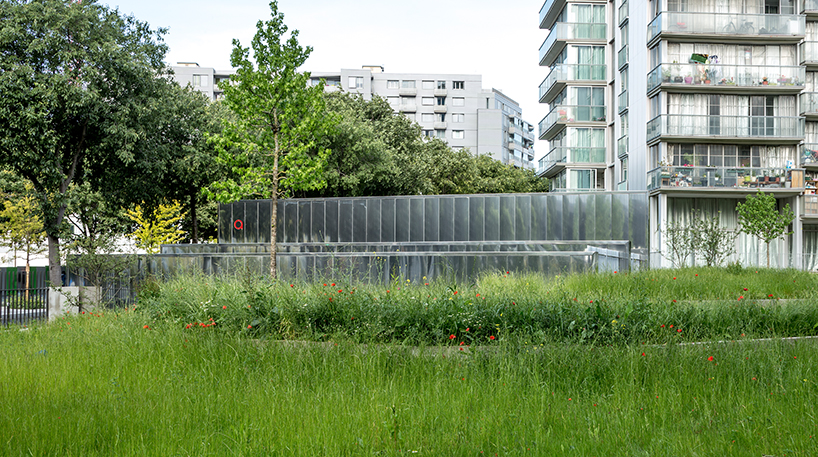 anonyme studio balances the raw structure of an underground parking with red splashes