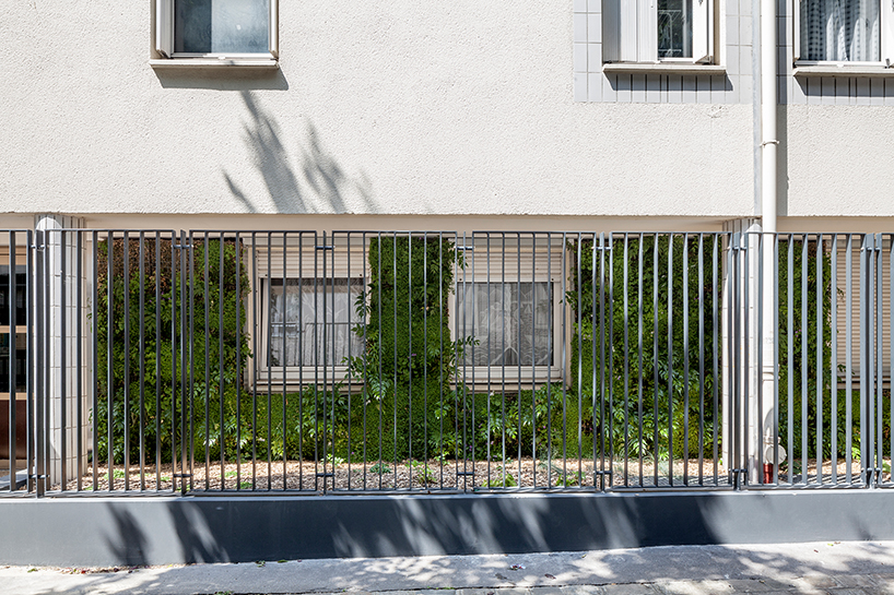 anonyme studio fully covers a parisian building façade with plants