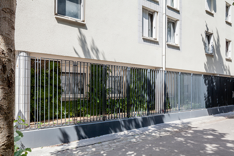 anonyme studio fully covers a parisian building façade with plants