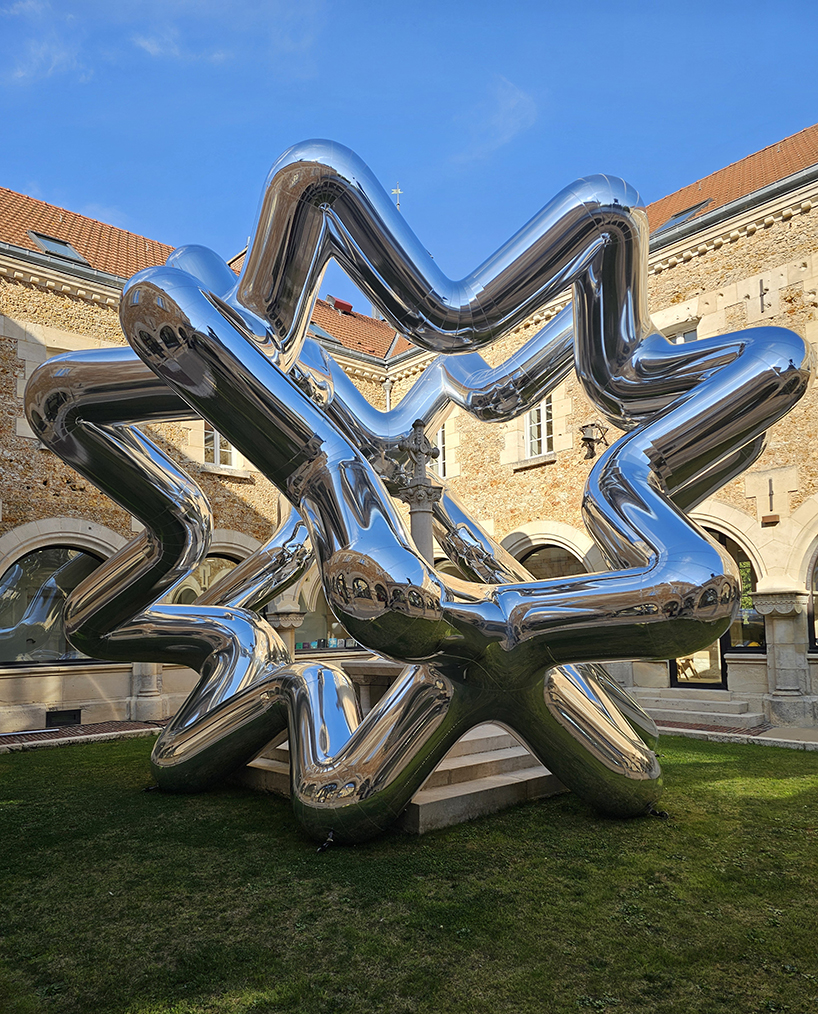 cyril lancelin's inflatable sculpture of star loops reflects the courtyard of étrépagny library