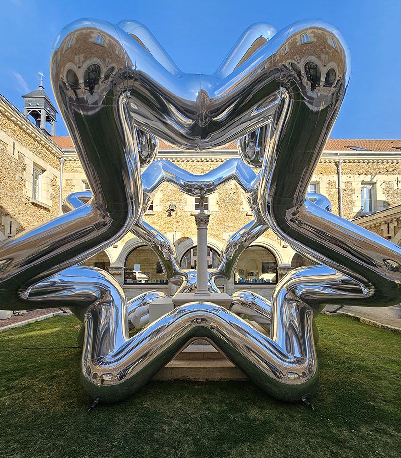 cyril lancelin's inflatable sculpture of star loops reflects the courtyard of étrépagny library