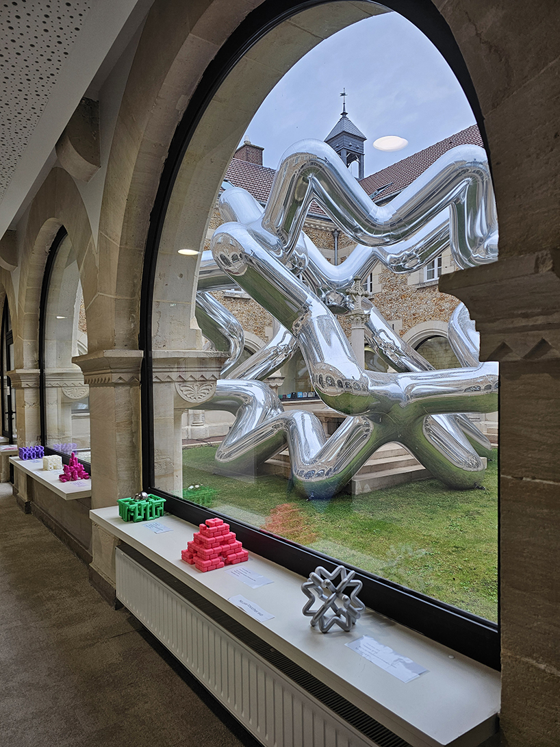 cyril lancelin's inflatable sculpture of star loops reflects the courtyard of étrépagny library
