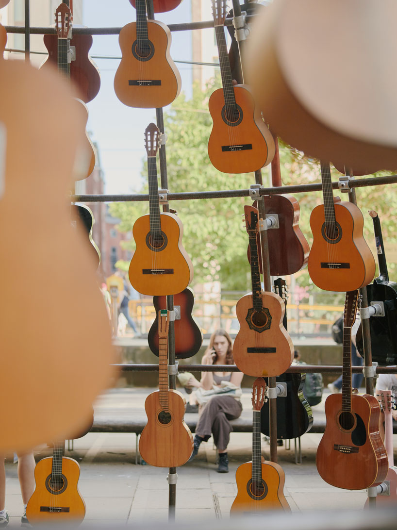 wind-powered sculpture turns donated guitars into sonic art installation in manchester