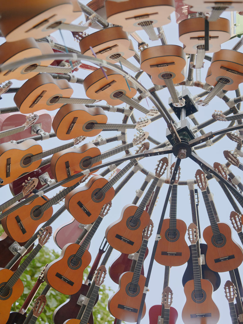 wind-powered sculpture turns donated guitars into sonic art installation in manchester