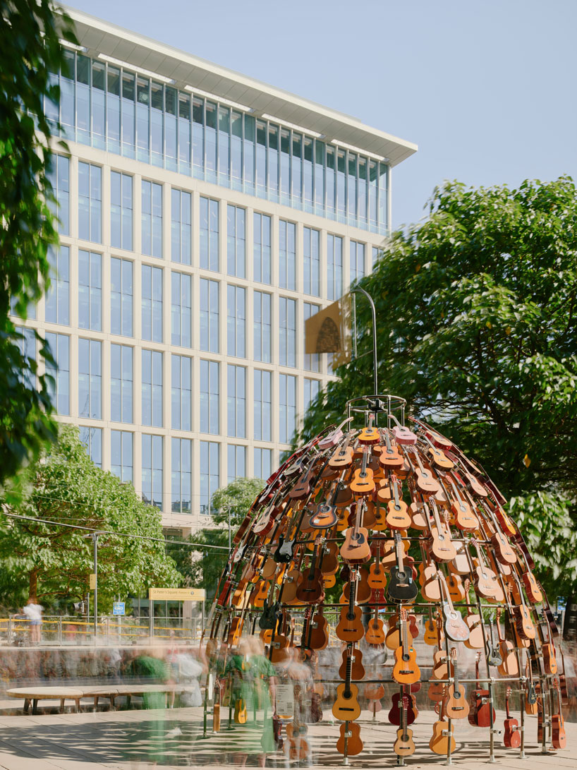 wind-powered sculpture turns donated guitars into sonic art installation in manchester
