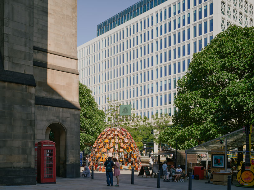 wind-powered sculpture turns donated guitars into sonic art installation in manchester