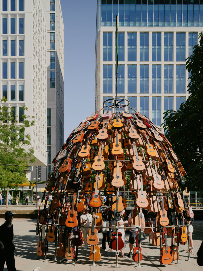 wind-powered sculpture turns donated guitars into sonic art installation in manchester
