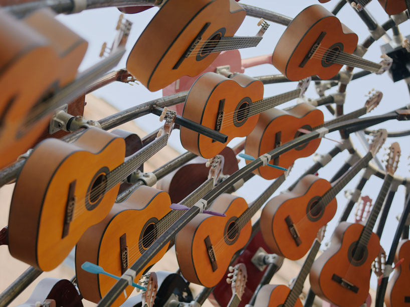 wind-powered sculpture turns donated guitars into sonic art installation in manchester