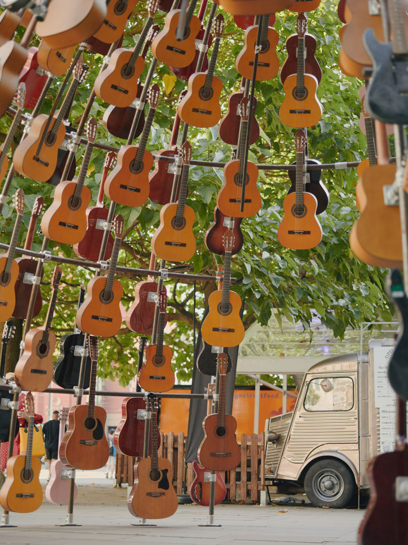 wind-powered sculpture turns donated guitars into sonic art installation in manchester