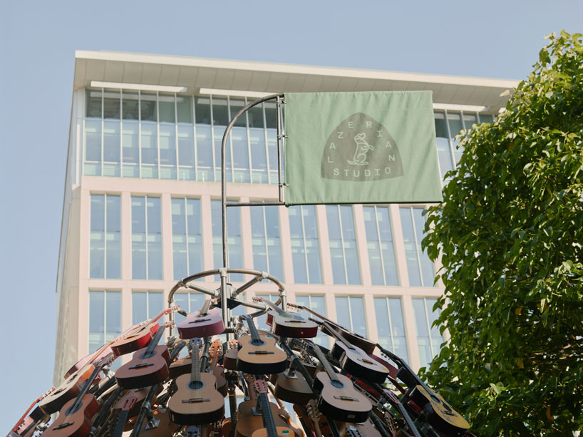 wind-powered sculpture turns donated guitars into sonic art installation in manchester