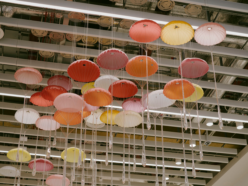 hundreds of suspended parachutes by lazerian drift above manchester airport’s terminal - 2