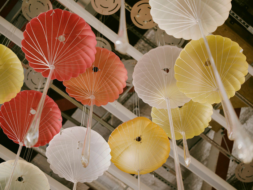 hundreds of suspended parachutes by lazerian drift above manchester airport’s terminal - 3