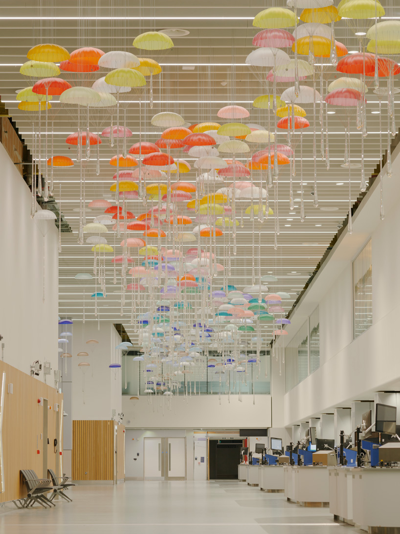 hundreds of suspended parachutes by lazerian drift above manchester airport’s terminal - 4