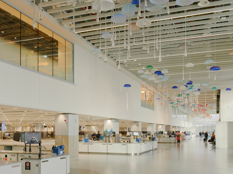 hundreds of suspended parachutes by lazerian drift above manchester airport’s terminal - 8