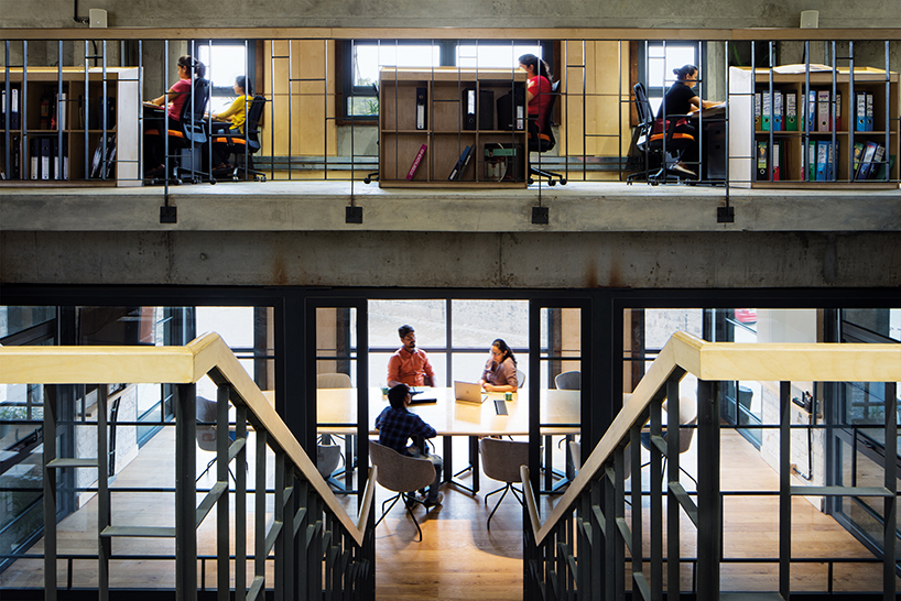 a brutalist concrete office building in india punctuated by corten steel, by groupDCA