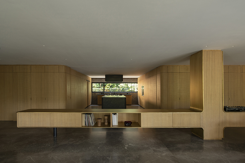 oak wood skin curves the edges of loma apartment in mexico