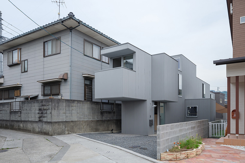 elongated house KJ lies on narrow flagpole lot between residences in japan