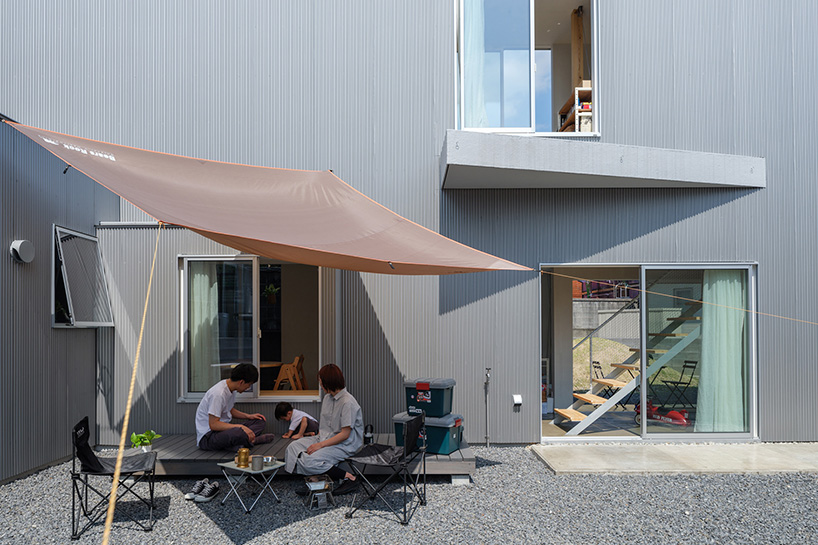 elongated house KJ lies on narrow flagpole lot between residences in japan