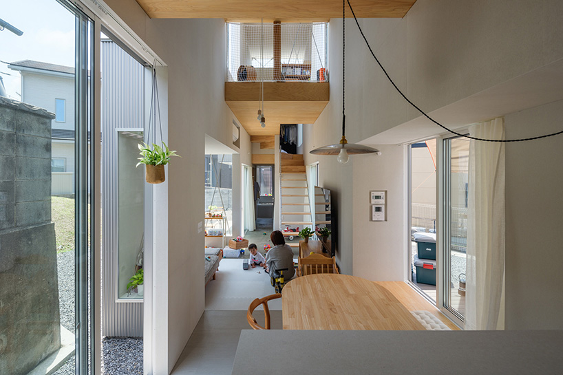 elongated house KJ lies on narrow flagpole lot between residences in japan