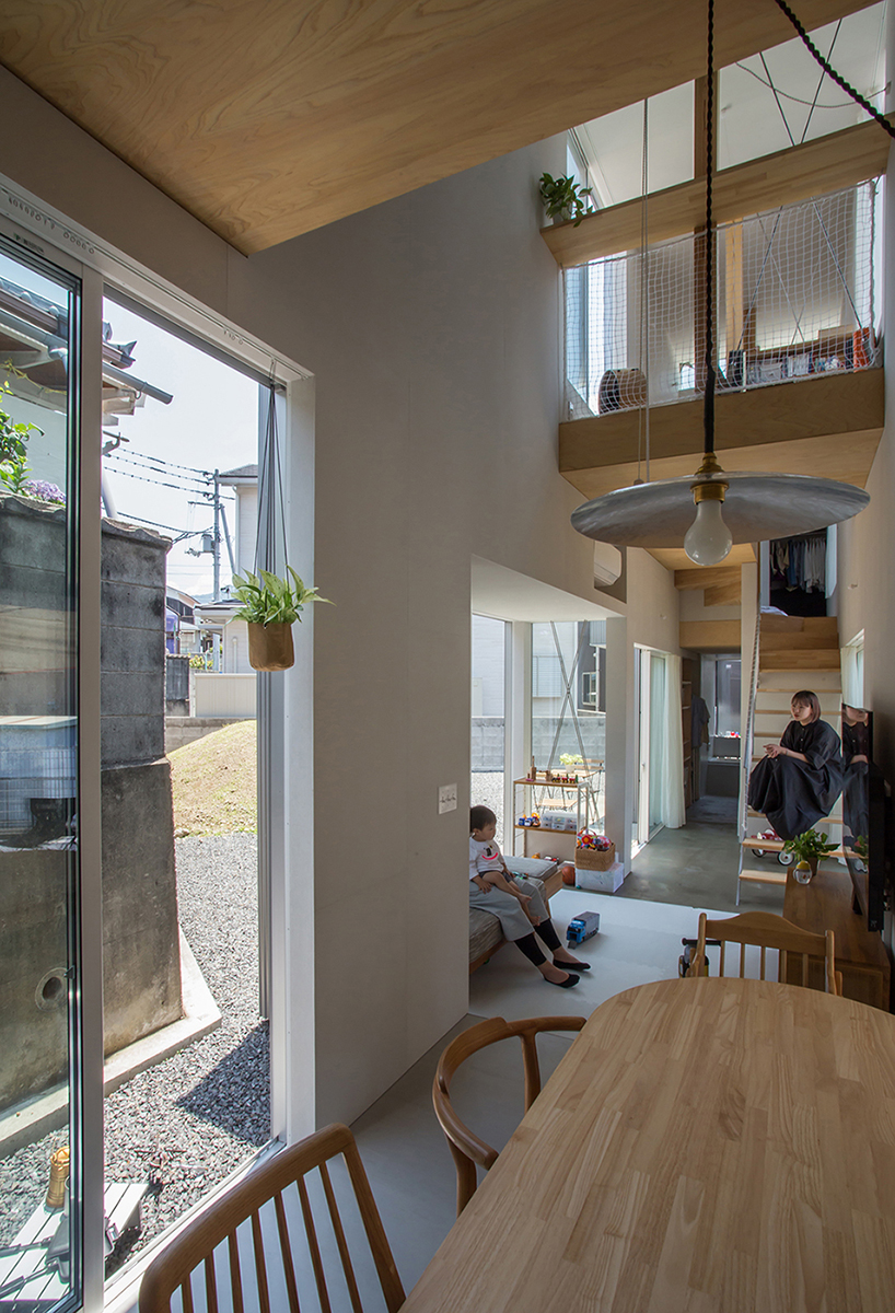 elongated house KJ lies on narrow flagpole lot between residences in japan