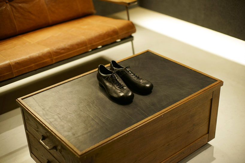 plus maizumi architect studio completes a shoe store with hanging walls in yokohama, japan